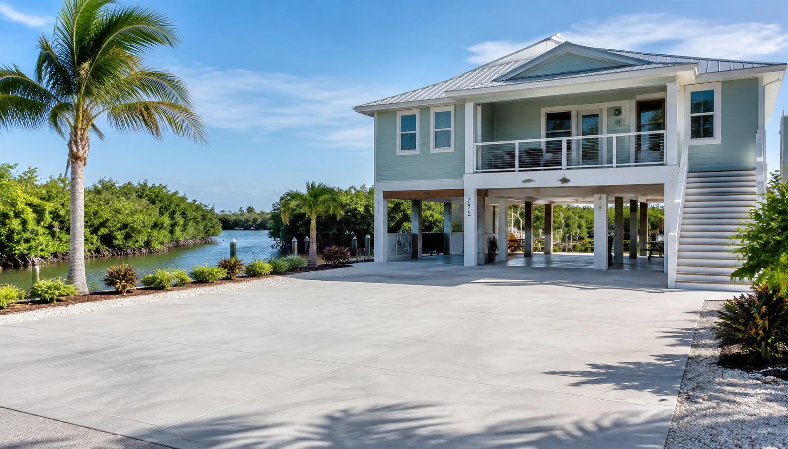 Wide concrete driveway and parking pad at a coastal stilt home in Crystal River, FL