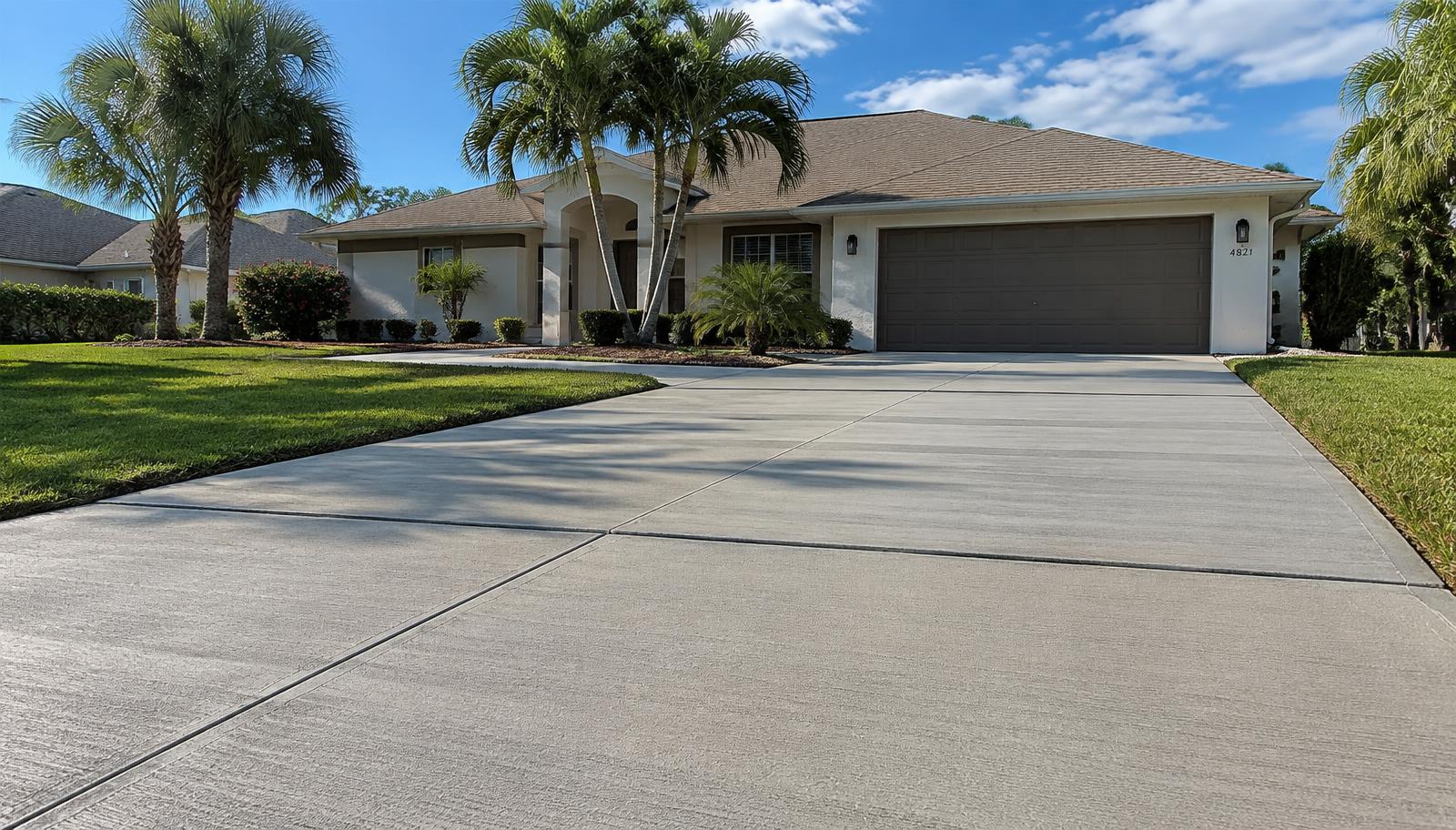 New broom-finish concrete driveway with clean control joints at a Citrus County, FL home
